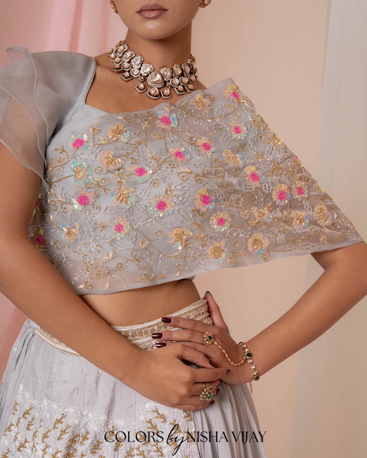 Lotus-print double-layer lehenga with orange cap-style frill blouse
