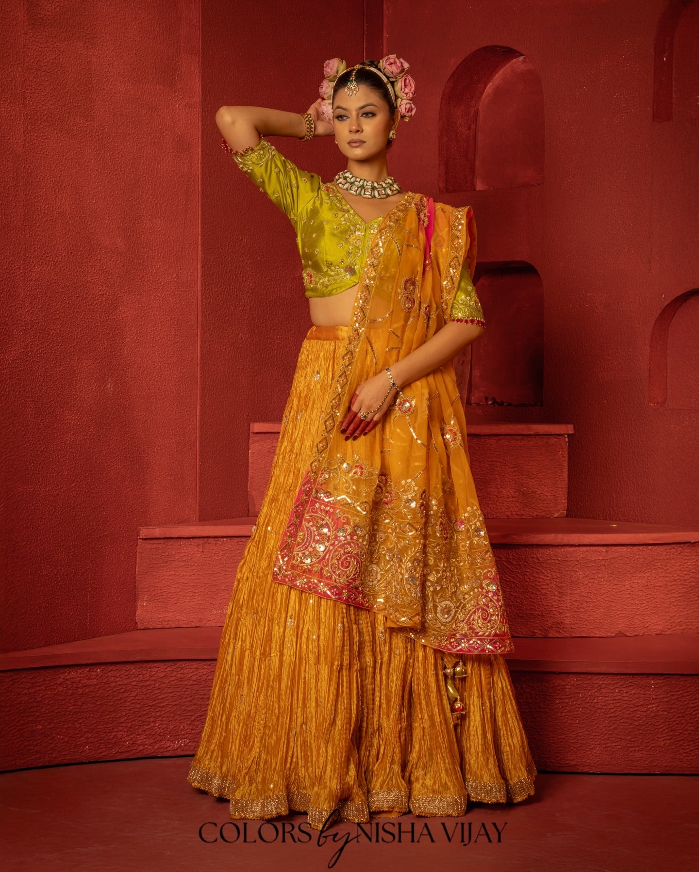 Bandhej-print dupatta paired with a flared/curled lehenga; gota flowers on the edge