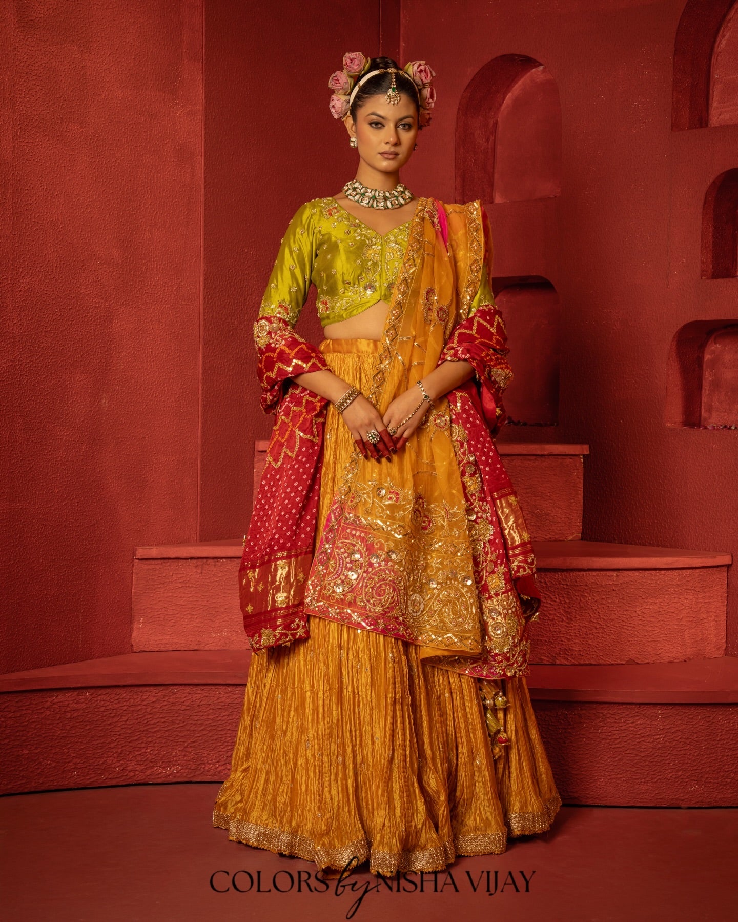 Bandhej-print dupatta paired with a flared/curled lehenga; gota flowers on the edge