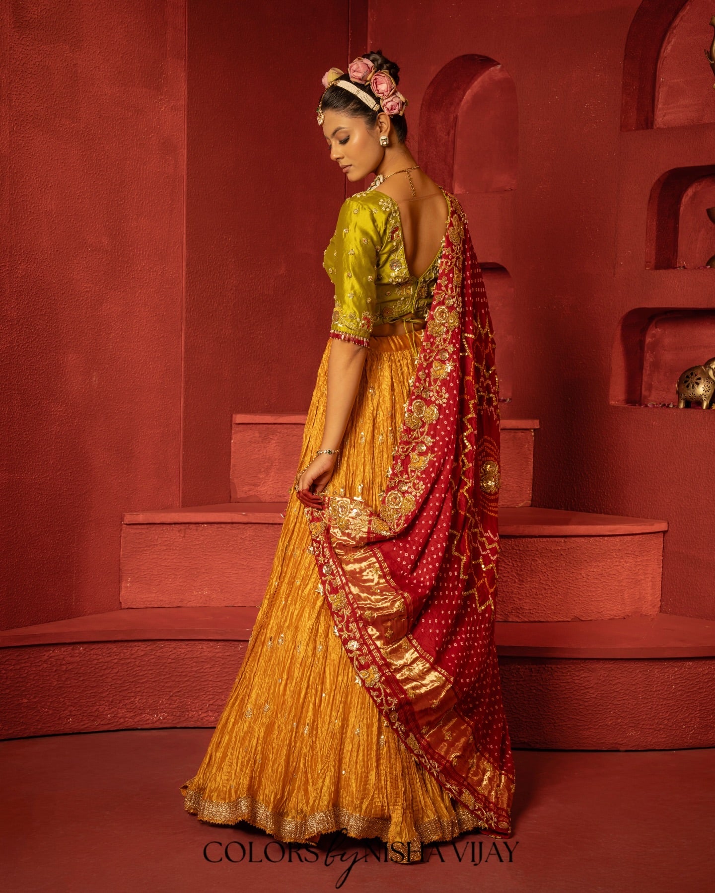 Bandhej-print dupatta paired with a flared/curled lehenga; gota flowers on the edge