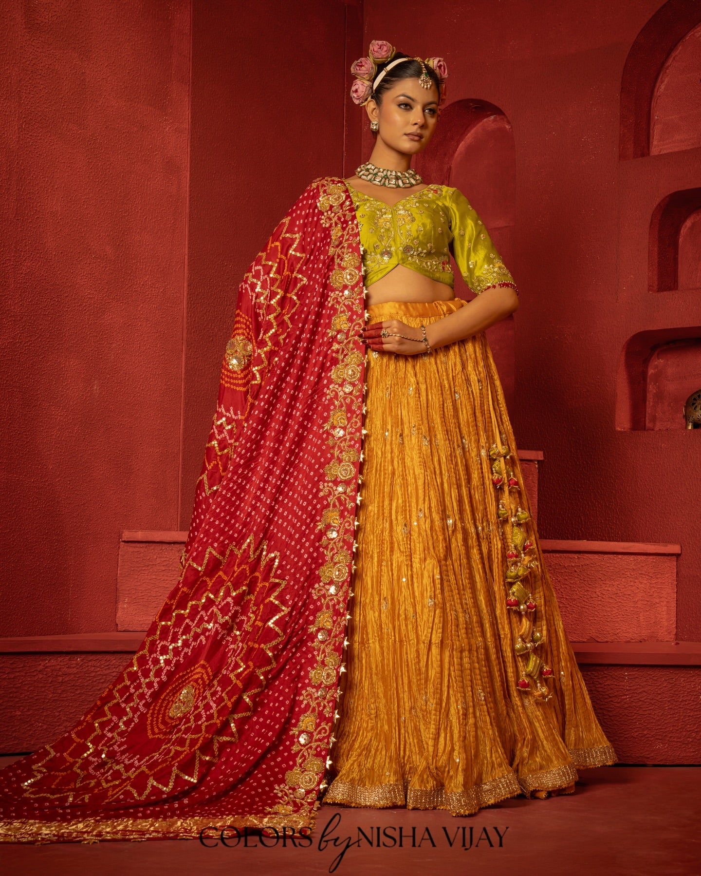 Bandhej-print dupatta paired with a flared/curled lehenga; gota flowers on the edge