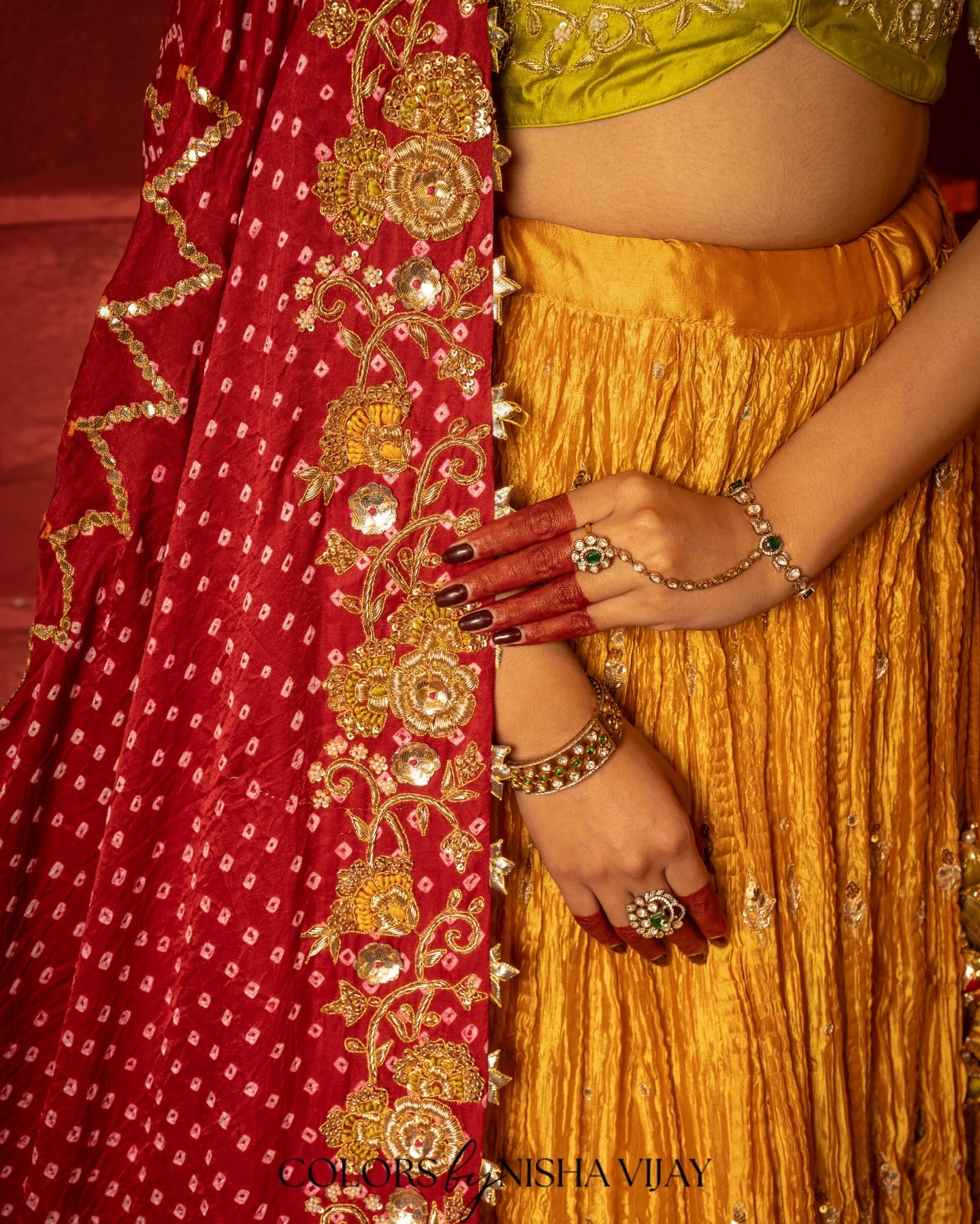 Bandhej-print dupatta paired with a flared/curled lehenga; gota flowers on the edge