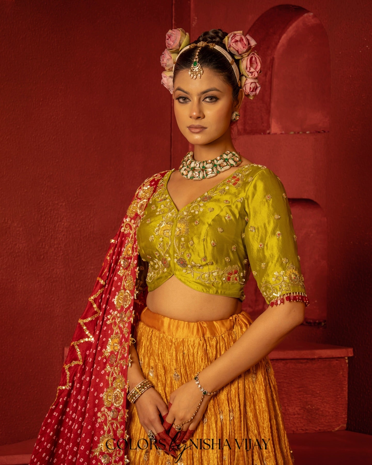 Bandhej-print dupatta paired with a flared/curled lehenga; gota flowers on the edge